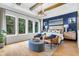 Luxurious bedroom featuring large windows, a blue accent wall, and comfortable seating at 1168 Reserve Ln, Awendaw, SC 29429