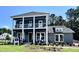 Inviting two-story home with a beautiful, covered double porch and professionally landscaped front yard at 1168 Reserve Ln, Awendaw, SC 29429