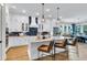 Bright kitchen featuring white cabinets, quartz countertops, pendant lighting, and stainless steel appliances at 1168 Reserve Ln, Awendaw, SC 29429