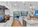 Modern kitchen featuring hardwood floors, white cabinets, granite countertops, and stainless steel appliances at 1168 Reserve Ln, Awendaw, SC 29429