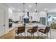 Modern kitchen with white cabinets, quartz countertops, pendant lighting, and stainless steel appliances at 1168 Reserve Ln, Awendaw, SC 29429