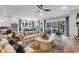 Spacious open-concept living area featuring comfortable seating, large windows, and a view of the backyard at 1168 Reserve Ln, Awendaw, SC 29429