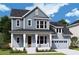 Charming two-story home with a covered front porch and manicured landscaping at 1195 Reserve Ln, Awendaw, SC 29429