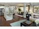 Open-concept living room with hardwood floors, a kitchen island, and an elegant dining area at 1195 Reserve Ln, Awendaw, SC 29429