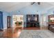 Open-concept living room with hardwood floors, dark wood entertainment center, and an adjoining dining area at 1227 Chuka Ct, Charleston, SC 29412