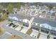 A neighborhood of townhomes with grey roofs, light siding, balconies, and screened porches is featured at 129 Sabal Ct, Summerville, SC 29483