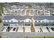 A neighborhood of townhomes with grey roofs, light siding, balconies, and screened porches is displayed at 129 Sabal Ct, Summerville, SC 29483
