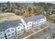 Aerial view of townhomes with white balconies and patios in a neighborhood surrounded by trees at 129 Sabal Ct, Summerville, SC 29483