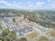 An aerial view displays a community with modern townhomes and single-Gathering homes, accented by ponds and verdant trees at 129 Sabal Ct, Summerville, SC 29483