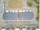 Aerial view of a neighborhood with townhomes that have grey roofs, light siding, and landscaped yards at 129 Sabal Ct, Summerville, SC 29483