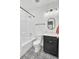 Well lit bathroom with a shower-tub combo, toilet, and sink with decorative black and white tile floors at 129 Sabal Ct, Summerville, SC 29483