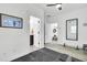 Bright bathroom features patterned tile flooring, a dark vanity, and a black framed mirror at 129 Sabal Ct, Summerville, SC 29483