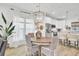 Open dining area adjacent to kitchen, featuring bright windows and hardwood floors at 129 Sabal Ct, Summerville, SC 29483