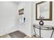 Entryway featuring a glass door, interior storm shade, decor table and modern mirror at 129 Sabal Ct, Summerville, SC 29483