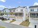 View of new construction of townhomes with charming screened-in porches, garages, and modern architectural details at 129 Sabal Ct, Summerville, SC 29483
