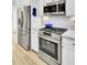 Well-equipped kitchen with stainless steel appliances, including a refrigerator, oven, and microwave, for modern convenience at 129 Sabal Ct, Summerville, SC 29483