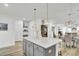 Spacious kitchen island with a light countertop and ample storage, seamlessly connecting to the dining area at 129 Sabal Ct, Summerville, SC 29483