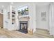 Living room with a fireplace, decorative mantle, and built-in shelving at 129 Sabal Ct, Summerville, SC 29483