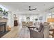 Inviting living room with a fireplace, large windows, comfortable seating, and stylish decor, creating a cozy atmosphere at 129 Sabal Ct, Summerville, SC 29483