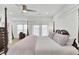 Bright main bedroom with a four-poster bed, neutral accents, and light wood flooring at 129 Sabal Ct, Summerville, SC 29483