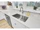Close-up of a sink with bright white countertops and neutral backsplash, showcasing a clean and modern design at 129 Sabal Ct, Summerville, SC 29483