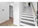 Staircase with a hardwood floor landing and white risers with gray treads at 129 Sabal Ct, Summerville, SC 29483