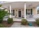 Inviting front porch with classic columns, a ceiling fan, and a swing at 1435 Swamp Fox Ln, Charleston, SC 29412