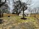 View of the fenced grassy backyard with a storage shed at 1508 Greenbay Dr, North Charleston, SC 29406