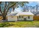 Home exterior with a new metal roof, wooden fence, and well-maintained backyard at 1508 Greenbay Dr, North Charleston, SC 29406
