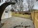 View of the fenced gravel and grass backyard with a storage shed at 1508 Greenbay Dr, North Charleston, SC 29406