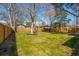 Expansive backyard featuring a wooden privacy fence and mature trees creating a serene outdoor space at 1508 Greenbay Dr, North Charleston, SC 29406