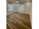 Bright bedroom with wood-look flooring and two windows for plenty of natural light at 1508 Greenbay Dr, North Charleston, SC 29406