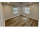 Serene bedroom featuring wood-look flooring, white walls, and ample natural light from the windows with blinds at 1508 Greenbay Dr, North Charleston, SC 29406