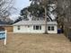 Charming single-story home featuring a metal roof, complemented by mature trees and an inviting front lawn at 1508 Greenbay Dr, North Charleston, SC 29406