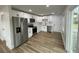 Modern kitchen featuring stainless steel appliances, white cabinets, and quartz countertops, complemented by stylish flooring at 1508 Greenbay Dr, North Charleston, SC 29406