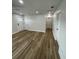 Bright living room featuring wood-look flooring and white trim, complemented by recessed lighting throughout at 1508 Greenbay Dr, North Charleston, SC 29406