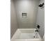 Modern shower with gray tiling, black fixtures, and an integrated shower niche at 1508 Greenbay Dr, North Charleston, SC 29406