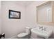 Bathroom featuring a sink, toilet, and framed artwork at 16 42Nd Ave, Isle of Palms, SC 29451