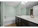 Bathroom featuring double vanity, soaking tub, and updated fixtures at 1706 Restoration Ct, Charleston, SC 29414