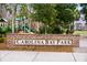 Carolina Bay Park brick entrance sign with nearby playground and tropical landscaping at 1706 Restoration Ct, Charleston, SC 29414