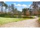 Scenic view of a pond with manicured grassy edges and a winding walking path at 1706 Restoration Ct, Charleston, SC 29414