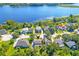 Wide aerial shot of a neighborhood with mature trees and waterfront homes, with a nearby lake at 1756 Indigo Island Dr, Hanahan, SC 29410
