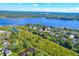 Overhead view of a neighborhood with mature trees, winding waterways, and a large lake in the background at 1756 Indigo Island Dr, Hanahan, SC 29410