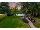 Manicured backyard featuring a water view, lush landscaping, and privacy fencing at 1756 Indigo Island Dr, Hanahan, SC 29410