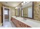 Bathroom features a dual sink vanity, mirrors and tiled floors at 1756 Indigo Island Dr, Hanahan, SC 29410