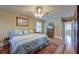 Bedroom with hardwood floors, ceiling fan and natural light streaming through the window at 1756 Indigo Island Dr, Hanahan, SC 29410