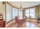 Charming dining room featuring a chandelier, wood floors and classic plantation shutters at 1756 Indigo Island Dr, Hanahan, SC 29410