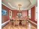 Formal dining room featuring wainscoting, stylish chandelier, and seating for eight at 1756 Indigo Island Dr, Hanahan, SC 29410