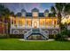 Elegant home featuring a large front porch, well-maintained lawn, and mature trees, providing curb appeal at 1756 Indigo Island Dr, Hanahan, SC 29410
