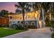 Elegant two-story home with a wrap-around porch, lush landscaping, and a spacious driveway at 1756 Indigo Island Dr, Hanahan, SC 29410